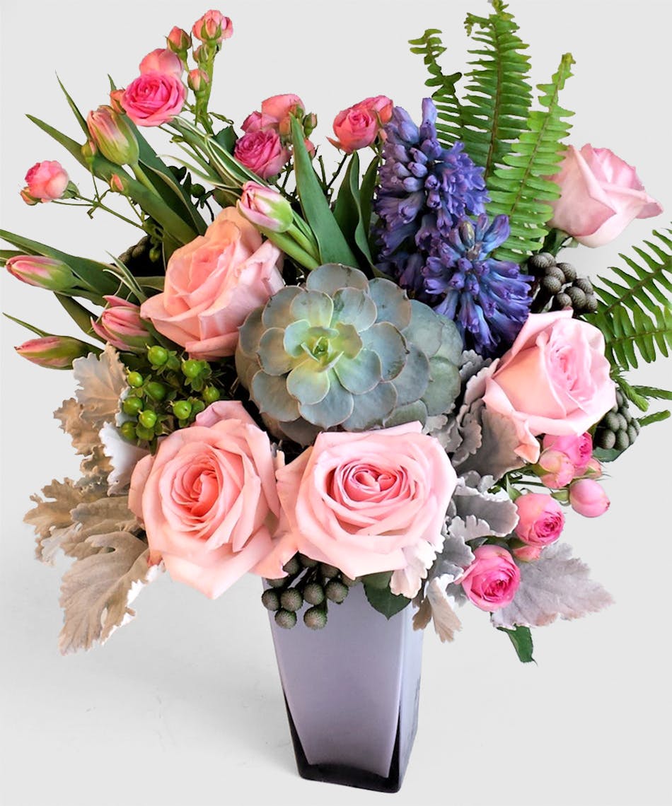Mixed Pastel shades of roses, tulips , Hyacinth and modern succulents nested high quality lavender glass vase