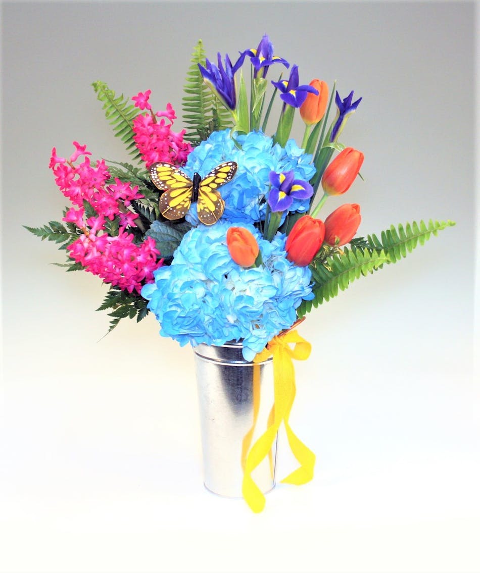 complete with a cute tin vase. A butterfly and a bright ribbon put the finishing touches on a perfect day!